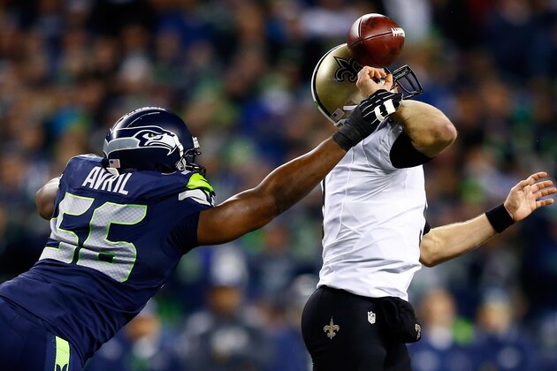 SEATTLE, WA - DECEMBER 02:  Defensive end Cliff Avril #56 of the Seattle Seahawks knocks the ball from quarterback Drew Brees #9 of the New Orleans Saints in the first quarter during a game at CenturyLink Field on December 2, 2013 in Seattle, Washington.  (Photo by Jonathan Ferrey/Getty Images)