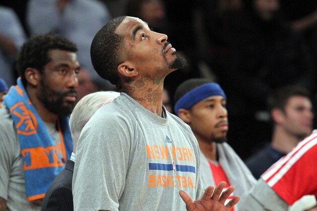 Jan 9, 2014; New York, NY, USA; New York Knicks shooting guard J.R. Smith (8) watches the final seconds of the game from the bench during the fourth quarter of a game against the Miami Heat at Madison Square Garden. Smith didn't play in the game. Mandatory Credit: Brad Penner-USA TODAY Sports