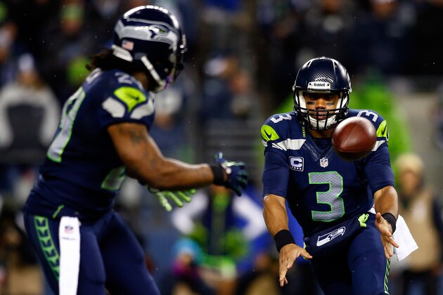 SEATTLE, WA - DECEMBER 02: Quarterback Russell Wilson #3 tosses the ball to running back Marshawn Lynch #24 of the Seattle Seahawks against the New Orleans Saints during a game at CenturyLink Field on December 2, 2013 in Seattle, Washington.  (Photo by Jonathan Ferrey/Getty Images)