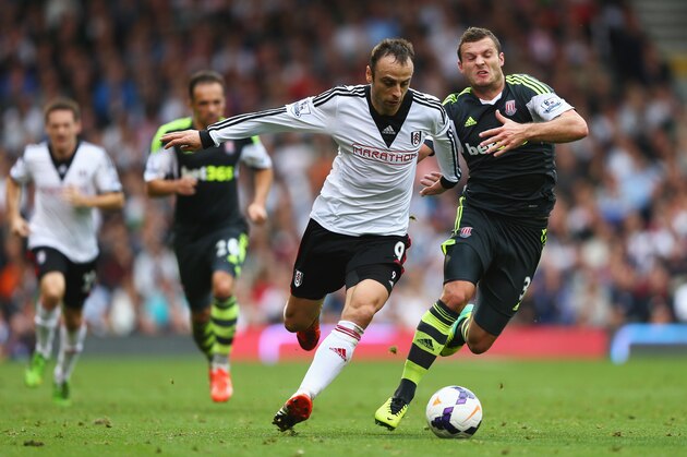 LONDON, ENGLAND - OCTOBER 05: Dimitar Berbatov of Fulham takes on Erik Pieters of Stoke City during the Barclays Premier League match between Fulham and Stoke City at Craven Cottage on October 5, 2013 in London, England.  (Photo by Paul Gilham/Getty Images)