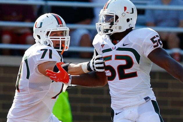 CHESTNUT HILL, MA - SEPTEMBER 01: Denzel Perryman #52 of the Miami Hurricanes is congratulated by teammate Anthony Chickillo #71 after scoring a touchdown on a returned interception against the Boston College Eagles during the game on September 1, 2012 at Alumni Stadium in Chestnut Hill, Massachusetts.  (Photo by Jared Wickerham/Getty Images)