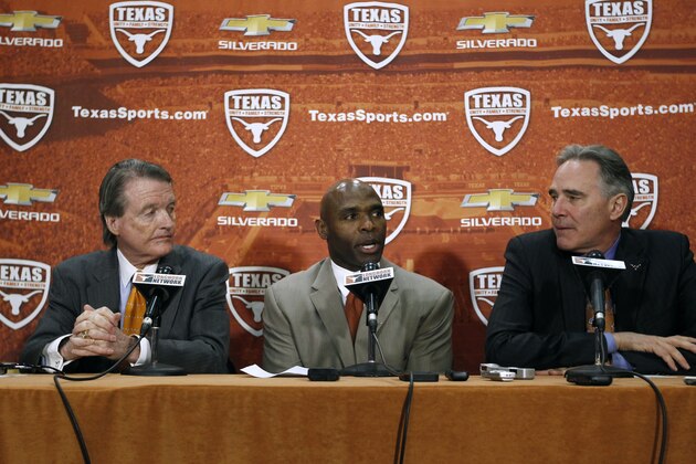 AUSTIN, TX - JANUARY 6:  University of Texas president Bill Powers, left and athletic director Steve Patterson, right, introduce new Longhorns head football coach Charlie Strong from Louisville during a press conference January 6, 2014 at Darrell K. Royal-Texas Memorial Stadium in Austin, Texas.  (Photo by Erich Schlegel/Getty Images)