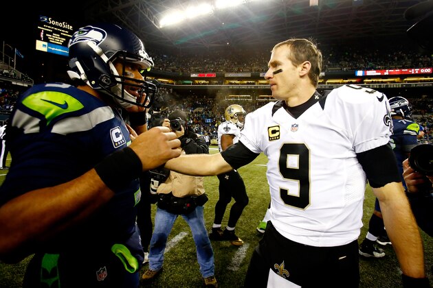 SEATTLE, WA - DECEMBER 02: Quarterback Russell Wilson #3 of the Seattle Seahawks and quarterback Drew Brees #9 of the New Orleans Saints meet on the field after the Seattle Seahawks defeated the New Orleans Saints 34-7 in a game at CenturyLink Field on December 2, 2013 in Seattle, Washington. (Photo by Jonathan Ferrey/Getty Images) SEATTLE, WA - DECEMBER 02: Quarterback Russell Wilson #3 of the Seattle Seahawks and quarterback Drew Brees #9 of the New Orleans Saints meet on the field after the Seattle Seahawks defeated the New Orleans Saints 34-7 in a game at CenturyLink Field on December 2, 2013 in Seattle, Washington. (Photo by Jonathan Ferrey/Getty Images)