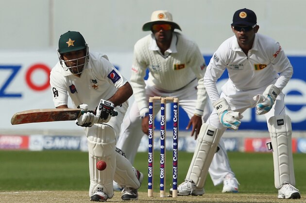 DUBAI, UNITED ARAB EMIRATES - JANUARY 08:  Sarfraz Ahmed of Pakistan bats as Prasanna Jayawardene of Sri Lanka looks on during the first day of the second Test match between Pakistan and Sri Lanka at the Dubai Sports City Cricket Stadium on January 8, 2014 in Dubai, United Arab Emirates.  (Photo by Francois Nel/Getty Images)
