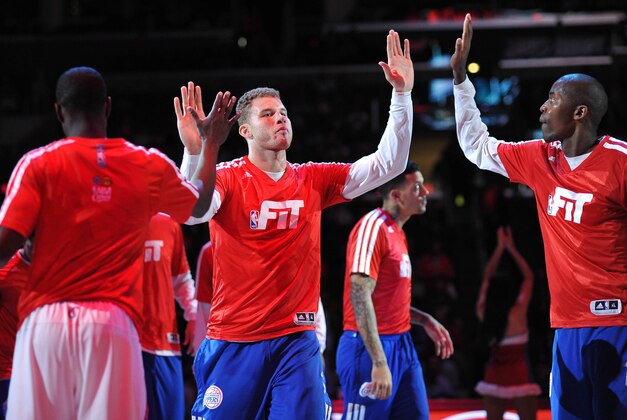 Jan 6, 2014; Los Angeles, CA, USA; Los Angeles Clippers power forward Blake Griffin (center) high fives teammates point guard Darren Collison (left) and shooting guard Jamal Crawford (right) during introductions before a game against the Orlando Magic at Staples Center. The Clippers defeated the Magic 101-81. Mandatory Credit: Andrew Fielding-USA TODAY Sports
