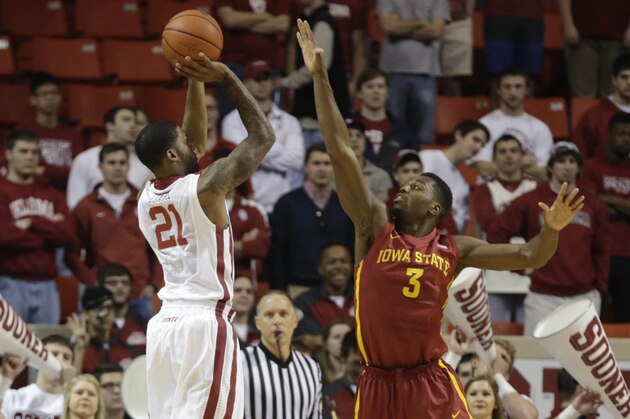 Jan 11, 2014; Norman, OK, USA; Oklahoma Sooners forward Cameron Clark (21) shoots over Iowa State Cyclones forward Melvin Ejim (3) in the first half at Lloyd Noble Center. Mandatory Credit: Tim Heitman-USA TODAY Sports