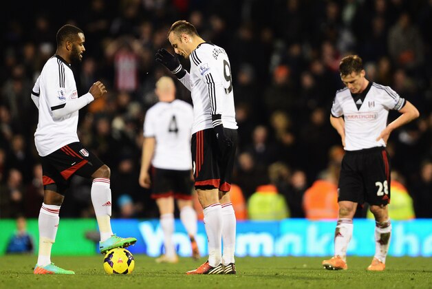 LONDON, ENGLAND - JANUARY 11:  (L-R) Fulham players Darren Bent, Dimitar Berbatov and Scott Parker react as they prepare to restart the game after conceding a goal during the Barclays Premier League match between Fulham and Sunderland at Craven Cottage on January 11, 2014 in London, England.  (Photo by Jamie McDonald/Getty Images)