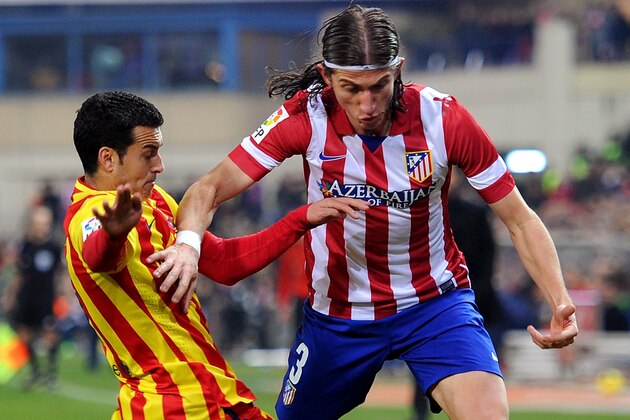 MADRID, SPAIN - JANUARY 11:  Pedro Rodriguez (L) of FC Barcelona tackles Felipe Luis of Club Atletico de Madrid of Club Atletico de Madrid during the La Liga match between Club Atletico de Madrid and FC Barcelona  at Vicente Calderon Stadium on January 11, 2014 in Madrid, Spain.  (Photo by Denis Doyle/Getty Images)