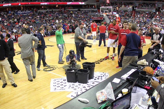 Jan 11, 2014; Washington, DC, USA; Washington Wizards and Houston Rockets players stand on the court during a delay in play for a leak in the roof during the second quarter at Verizon Center. Mandatory Credit: Geoff Burke-USA TODAY Sports