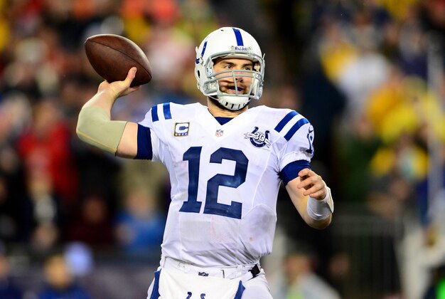 Jan 11, 2014; Foxborough, MA, USA; Indianapolis Colts quarterback Andrew Luck (12) throws a pass during the fourth quarter of the 2013 AFC divisional playoff football game against the New England Patriots at Gillette Stadium. Mandatory Credit: Andrew Weber-USA TODAY Sports