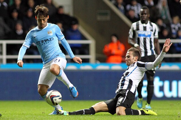 NEWCASTLE, UNITED KINGDOM - OCTOBER 30: Yohan Cabaye of Newcastle United (right) makes a challenge on David Silva of Manchester City during the Capital One Cup Fourth Round match between Newcastle United and Manchester City at St James' Park on October 30, 2013 in Newcastle upon Tyne, England (Photo by Ian Horrocks/Getty Images)