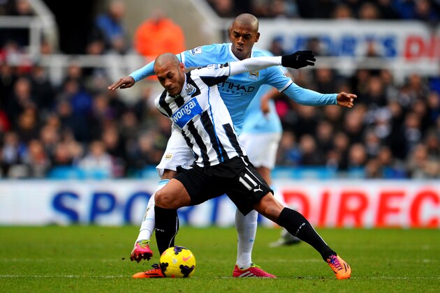 NEWCASTLE UPON TYNE, ENGLAND - JANUARY 12:  Yoan Gouffran of Newcastle is tackled by Fernandinho of Manchester City during the Barclays Premier League match between Newcastle United and Manchester City at St James' Park on January 12, 2014 in Newcastle upon Tyne, England.  (Photo by Michael Regan/Getty Images)