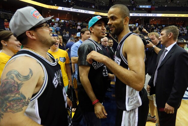 May 27, 2013; Memphis, TN, USA; San Antonio Spurs point guard Tony Parker (9) celebrates with fans in the stands after game four of the Western Conference finals of the 2013 NBA Playoffs against the Memphis Grizzlies at FedEx Forum. The Spurs won 93-86. Mandatory Credit: Nelson Chenault-USA TODAY Sports