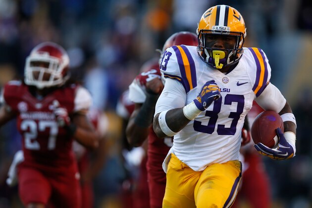 BATON ROUGE, LA - NOVEMBER 29:  Jeremy Hill #33 of the LSU Tigers scores a touchdown against the Arkansas Razorbacks at Tiger Stadium on November 29, 2013 in Baton Rouge, Louisiana.  The Tigers defeated the Razorbacks 31-27.  (Photo by Chris Graythen/Getty Images)
