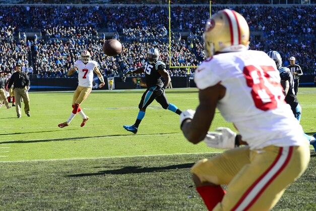 Jan 12, 2014; Charlotte, NC, USA; San Francisco 49ers quarterback Colin Kaepernick (7) throws a touchdown to tight end Vernon Davis (85) against the Carolina Panthers during the second quarter of the 2013 NFC divisional playoff football game at Bank of America Stadium. Mandatory Credit: Bob Donnan-USA TODAY Sports