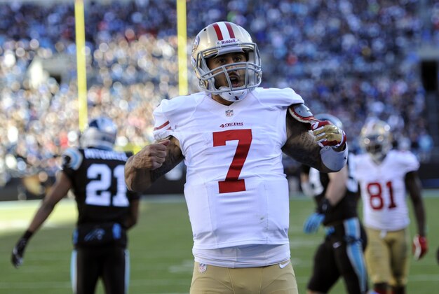 Jan 12, 2014; Charlotte, NC, USA; San Francisco 49ers quarterback Colin Kaepernick (7) celebrates a touchdown against the Carolina Panthers during the third quarter of the 2013 NFC divisional playoff football game at Bank of America Stadium. Mandatory Credit: Sam Sharpe-USA TODAY Sports