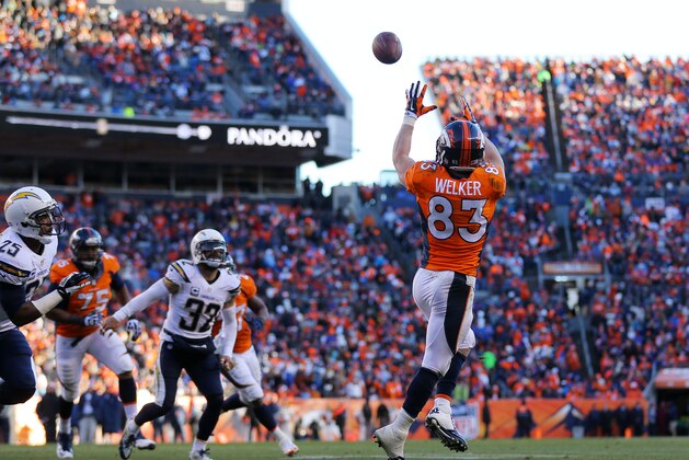 DENVER, CO - JANUARY 12:  Wes Welker #83 of the Denver Broncos completes a second quarter touchdown pass against the San Diego Chargers during the AFC Divisional Playoff Game at Sports Authority Field at Mile High on January 12, 2014 in Denver, Colorado.  (Photo by Justin Edmonds/Getty Images)