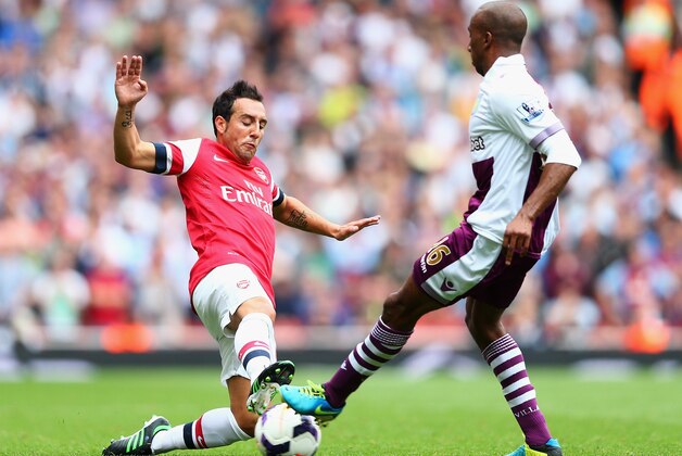 LONDON, ENGLAND - AUGUST 17:  Santi Cazorla of Arsenal and Fabian Delph of Aston Villa battle for the ball during the Barclays Premier League match between Arsenal and Aston Villa at Emirates Stadium on August 17, 2013 in London, England.  (Photo by Clive Mason/Getty Images)