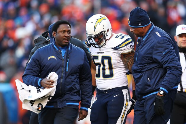 DENVER, CO - JANUARY 12:  Manti Te'o #50 of the San Diego Chargers is helped off of the field after being injured in the second quarter against the Denver Broncos during the AFC Divisional Playoff Game at Sports Authority Field at Mile High on January 12, 2014 in Denver, Colorado.  (Photo by Christian Petersen/Getty Images)