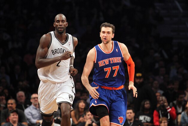 Dec 5, 2013; Brooklyn, NY, USA; New York Knicks power forward Andrea Bargnani (77) has words with Brooklyn Nets power forward Kevin Garnett (2) as they run up the court after Bargnani hits a three-point basket during the fourth quarter of a game at Barclays Center. Bargnani was immediately issues a second technical foul and ejected from the game. Mandatory Credit: Brad Penner-USA TODAY Sports