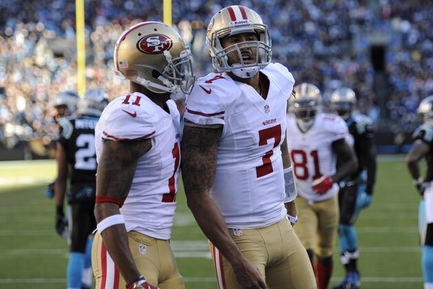 Jan 12, 2014; Charlotte, NC, USA; San Francisco 49ers quarterback Colin Kaepernick (7) celebrates a touchdown with wide receiver Quinton Patton (11) against the Carolina Panthers during the third quarter of the 2013 NFC divisional playoff football game at Bank of America Stadium. Mandatory Credit: Sam Sharpe-USA TODAY Sports