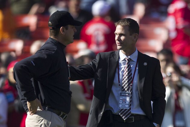 Jan 14, 2012; San Francisco, CA, USA; San Francisco 49ers head coach Jim Harbaugh (left) talks to general manager Trent Baalke (right) before the 2011 NFC divisional playoff game against the New Orleans Saints at Candlestick Park. Mandatory Credit: Jason O. Watson-USA TODAY Sports