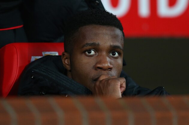 MANCHESTER, ENGLAND - JANUARY 05:  Wilfried Zaha of Manchester United looks on from the bench prior to the FA Cup with Budweiser Third round match between Manchester United and Swansea City at Old Trafford on January 5, 2014 in Manchester, England.  (Photo by Alex Livesey/Getty Images)