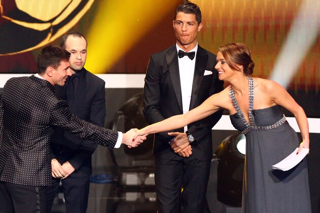 ZURICH, SWITZERLAND - JANUARY 07: Lionel Messi (L) shake hands with Kay Murray (R) and Andres Iniesta of Barcelona (2nd L) and Cristiano Ronaldo of Real Madrid (2nnd R) look thoughtful during the FIFA Ballon d'Or Gala 2013 at Congress House on January 07, 2013 in Zurich, Switzerland. (Photo by Christof Koepsel/Getty Images)