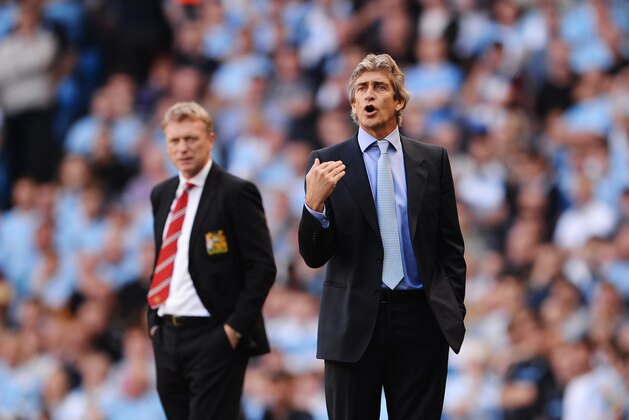 MANCHESTER, ENGLAND - SEPTEMBER 22:  David Moyes manager of Manchester United (L) and Manuel Pellegrini manager of Manchester City look on during the Barclays Premier League match between Manchester City and Manchester United at the Etihad Stadium on September 22, 2013 in Manchester, England.  (Photo by Michael Regan/Getty Images)