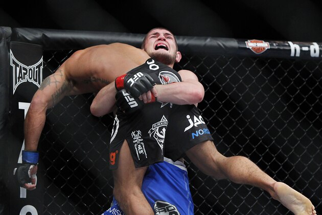 May 25, 2013; Las Vegas, NV, USA; Khabib Nurmagomedov strains to lift Abel Trujillo during UFC 160 at the MGM Grand Garden Arena. Mandatory Credit: Gary A. Vasquez-USA TODAY Sports