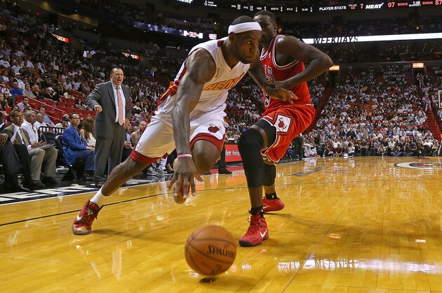 MIAMI, FL - OCTOBER 29: LeBron James #6 of the Miami Heat drives around Luol Deng #9 of the Chicago Bulls during a game  at American Airlines Arena on October 29, 2013 in Miami, Florida.  (Photo by Mike Ehrmann/Getty Images)