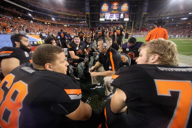 GLENDALE, AZ - JANUARY 02:  Offensive line coach Joe Wickline of the Oklahoma State Cowboys talks with his players on the sideline against the Stanford Cardinal during the Tostitos Fiesta Bowl on January 2, 2012 at University of Phoenix Stadium in Glendale, Arizona.  (Photo by Donald Miralle/Getty Images)