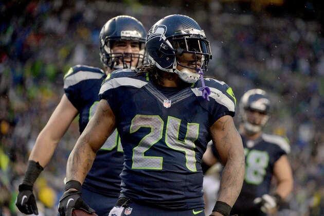 SEATTLE, WA - JANUARY 11:  Running back Marshawn Lynch #24 of the Seattle Seahawks celebrates after he scores a 31-yard touchdown run against the New Orleans Saints in the fourth quarter during the NFC Divisional Playoff Game at CenturyLink Field on January 11, 2014 in Seattle, Washington.  (Photo by Harry How/Getty Images)