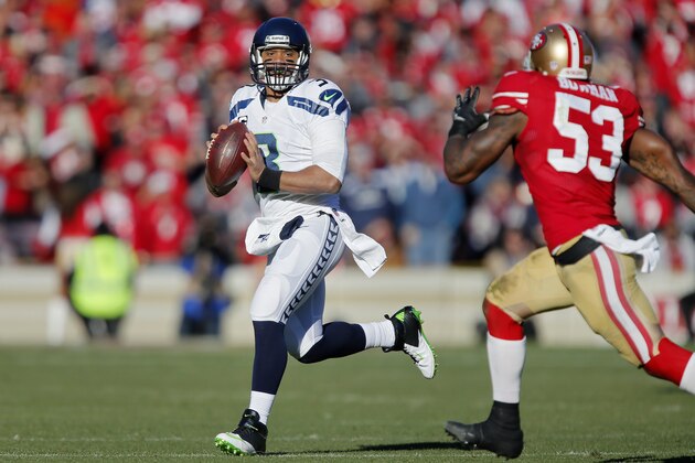 SAN FRANCISCO, CA - DECEMBER 08:  Quarterback Russell Wilson #3 of the Seattle Seahawks looks for a receiver against linebacker NaVorro Bowman #53 of the San Francisco 49ers in the second quarter on December 8, 2013 at Candlestick Park in San Francisco, California.  The 49ers won 19-17.  (Photo by Brian Bahr/Getty Images)
