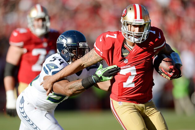 SAN FRANCISCO, CA - DECEMBER 08:  Colin Kaepernick #7 of the San Francisco 49ers scrambling with the ball gets grabbed by his jersey from Bobby Wagner #54 of the Seattle Seahawks during the first quarter at Candlestick Park on December 8, 2013 in San Francisco, California.  (Photo by Thearon W. Henderson/Getty Images)