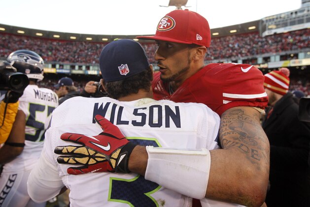 Dec 8, 2013; San Francisco, CA, USA; San Francisco 49ers quarterback Colin Kaepernick (7) talks with Seattle Seahawks quarterback Russell Wilson (3) after the game at Candlestick Park. The 49ers defeated the Seahawks 19-17. Mandatory Credit: Cary Edmondson-USA TODAY Sports