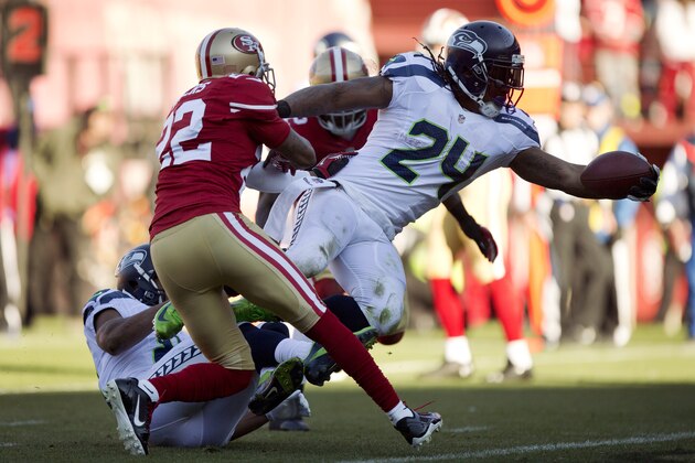 SAN FRANCISCO, CA - DECEMBER 08:  Running back Marshawn Lynch #24 of the Seattle Seahawks scores a touchdown against cornerback Carlos Rogers #22 and linebacker Patrick Willis #52 of the San Francisco 49ers in the first quarter on December 8, 2013 at Candlestick Park in San Francisco, California.  The 49ers won 19-17.  (Photo by Brian Bahr/Getty Images)