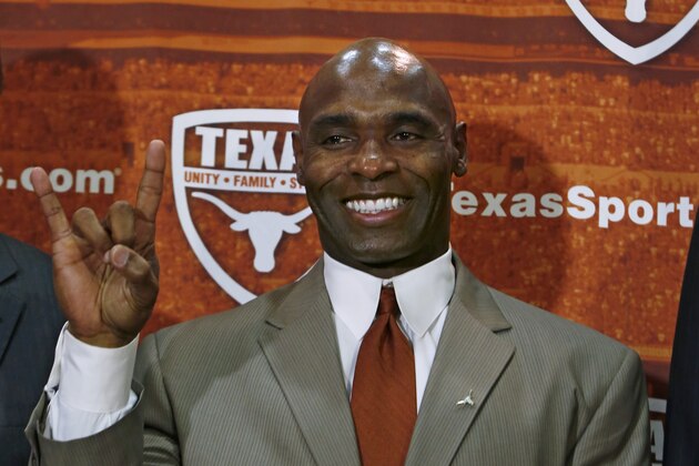 AUSTIN, TX - JANUARY 6: The University of Texas Longhorns new head football coach Charlie Strong from Louisville flashes the 'Hook 'Em Horns' sign after being introduced during a press conference January 6, 2014 at Darrell K. Royal-Texas Memorial Stadium in Austin, Texas.  (Photo by Erich Schlegel/Getty Images)