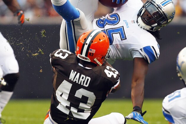 CLEVELAND, OH - OCTOBER 13:  Running back Joique Bell #35 of the Detroit Lions is tackled by defensive back T.J. Ward #43 of the Cleveland Browns at FirstEnergy Stadium on October 13, 2013 in Cleveland, Ohio.  (Photo by Matt Sullivan/Getty Images)