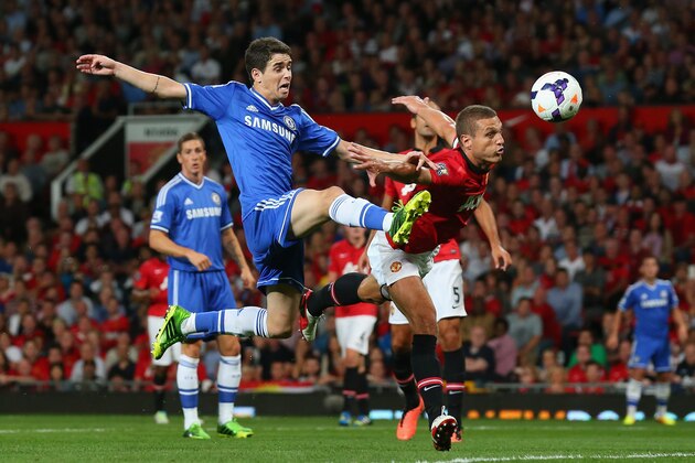 MANCHESTER, ENGLAND - AUGUST 26:  Oscar of Chelsea is challenged by Nemanja Vidic of Manchester United  during the Barclays Premier League match between Manchester United and Chelsea at Old Trafford on August 26, 2013 in Manchester, England.  (Photo by Alex Livesey/Getty Images)