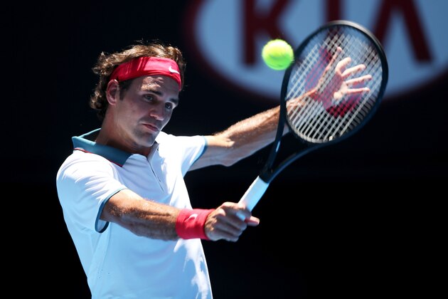 MELBOURNE, AUSTRALIA - JANUARY 14:  Roger Federer of Switzerland plays a backhand in his first round match against James Duckworth of Australia during day two of the 2014 Australian Open at Melbourne Park on January 14, 2014 in Melbourne, Australia.  (Photo by Clive Brunskill/Getty Images)