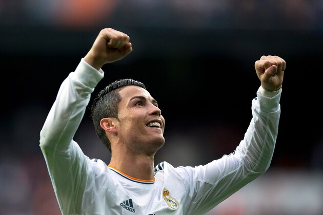 MADRID, SPAIN - NOVEMBER 09:  Cristiano Ronaldo of Real Madrid CF celebrates scoring their fifth goal during the La Liga match between Real Madrid CF and Real Sociedad de Futbol  at Estadio Santiago Bernabeu on November 9, 2013 in Madrid, Spain.  (Photo by Gonzalo Arroyo Moreno/Getty Images)