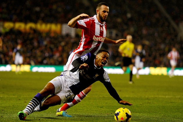 STOKE ON TRENT, ENGLAND - JANUARY 12:  Raheem Sterling of Liverpool is fouled by Marc Wilson of Stoke City for a penalty kick during the Barclays Premier League match between Stoke City and Liverpool at Britannia Stadium on January 12, 2014 in Stoke on Trent, England.  (Photo by Laurence Griffiths/Getty Images)