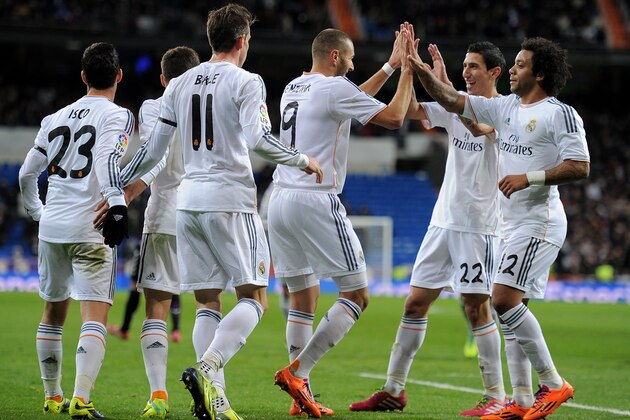 MADRID, SPAIN - NOVEMBER 30:  Karim Benzema (#9) of Real Madrid CF celebrates with Angel Di Maria (2.R) and Marcelo (R) after scoring Real's 2nd goal during the La Liga match between Real Madrid CF and Real Valladolid CF at Santiago Bernabeu stadium on November 30, 2013 in Madrid, Spain.  (Photo by Denis Doyle/Getty Images)