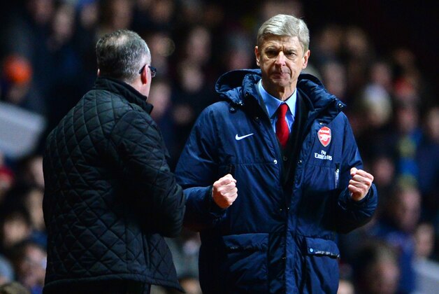 BIRMINGHAM, ENGLAND - JANUARY 13:  Arsene Wenger manager of Arsenal reacts at the final whistle as he turns to Manager Paul Lambert of Aston Villa during the Barclays Premier League match between Aston Villa and Arsenal at Villa Park on January 13, 2014 in Birmingham, England.  (Photo by Michael Regan/Getty Images)