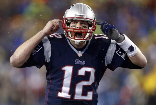 Jan 11, 2014; Foxborough, MA, USA; New England Patriots quarterback Tom Brady (12) gestures at the line in the second half during the 2013 AFC divisional playoff football game against the Indianapolis Colts at Gillette Stadium. Mandatory Credit: Mark L. Baer-USA TODAY Sports