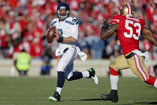 SAN FRANCISCO, CA - DECEMBER 08:  Quarterback Russell Wilson #3 of the Seattle Seahawks looks for a receiver against linebacker NaVorro Bowman #53 of the San Francisco 49ers in the second quarter on December 8, 2013 at Candlestick Park in San Francisco, California.  The 49ers won 19-17.  (Photo by Brian Bahr/Getty Images)