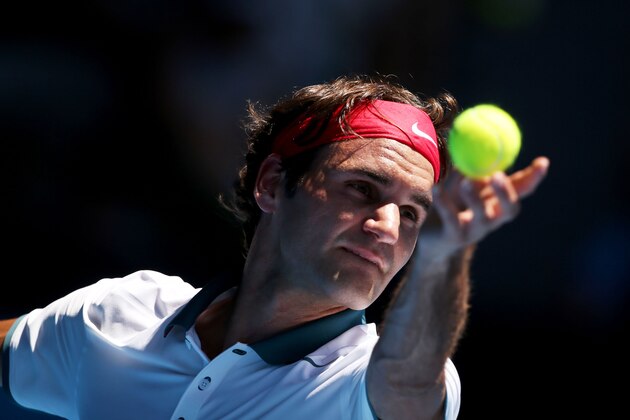 MELBOURNE, AUSTRALIA - JANUARY 14:  Roger Federer of Switzerland serves in his first round match against James Duckworth of Australia during day two of the 2014 Australian Open at Melbourne Park on January 14, 2014 in Melbourne, Australia.  (Photo by Clive Brunskill/Getty Images)
