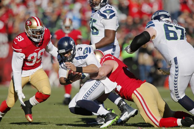 SAN FRANCISCO, CA - DECEMBER 08:  Defensive tackle Justin Smith #94 of the San Francisco 49ers sacks quarterback Russell Wilson #3 of the Seattle Seahawks for a loss of five yards in the first quarter on December 8, 2013 at Candlestick Park in San Francisco, California.  The 49ers won 19-17.  (Photo by Brian Bahr/Getty Images)