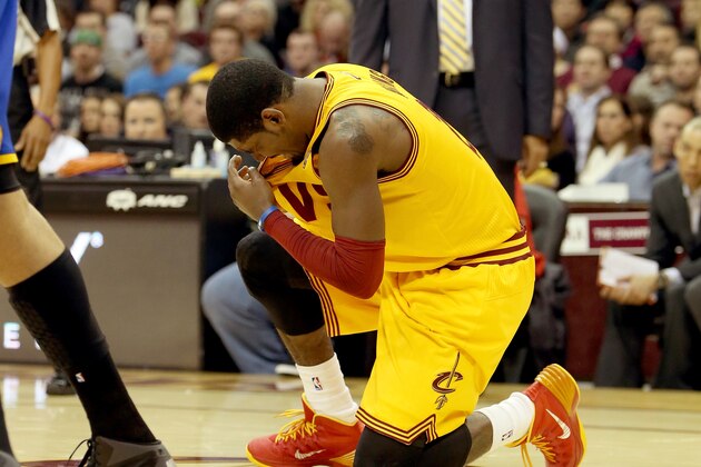 CLEVELAND, OH - DECEMBER 29: Kyrie Irving #2 of the Cleveland Cavaliers kneels on the court after being hit in the face in the second quarter against the Golden State Warriors at Quicken Loans Arena on December 29, 2013 in Cleveland, Ohio. NOTE TO USER: User expressly acknowledges and agrees that, by downloading and/or using this photograph, user is consenting to the terms and conditions of the Getty Images License Agreement.  (Photo by Mike Lawrie/Getty Images)